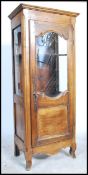 A 19th century French country oak vitrine display cabinet of upright form. The shaped legs with