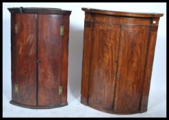 2 19th century Georgian flame mahogany bow fronted corner cabinets. One larger with inlaid marquetry