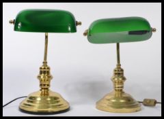 A pair of vintage matching 20th century bankers desk lamps having an adjustable green glass shades