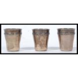 A group of three continental silver drinks measures toddy cups with continental silver marks to