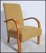 A 20th century Art Deco style bentwood armchair having shaped elbow rests in oak with overstuffed
