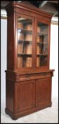 A 19th century mahogany bookcase cabinet having gl