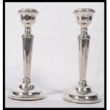 A pair of silver hallmarked filled stub candlesticks, Birmingham assay marks with makers marks for A