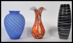 A collection of 3 20th century studio art glass vases to include black and white tube lined, blue