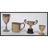 A group of silver hallmarked items to include a Christening cup and egg cup set a trophy on stand