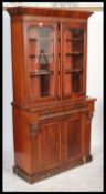 A Victorian mahogany library bookcase cupboard cabinet raised on a plinth base having twin door