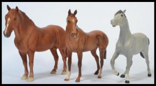 A group of three Beswick / Royal Doulton ceramic horses to include a Beswick England grey dappled