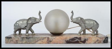 A 1930's Art Deco rouge marble and elephant table lamp. The silvered elepants flanking a frosted