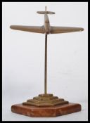 A vintage 20th century World War Two second World War WW2 trench art style brass model of a Spitfire
