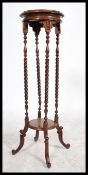 A Victorian style mahogany torchere plant stand raised on splayed feet with hoof feet, barley