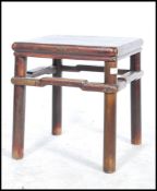 A 20th century Chinese lacquered  opium stool / side  table in elm wood. The stool / side table