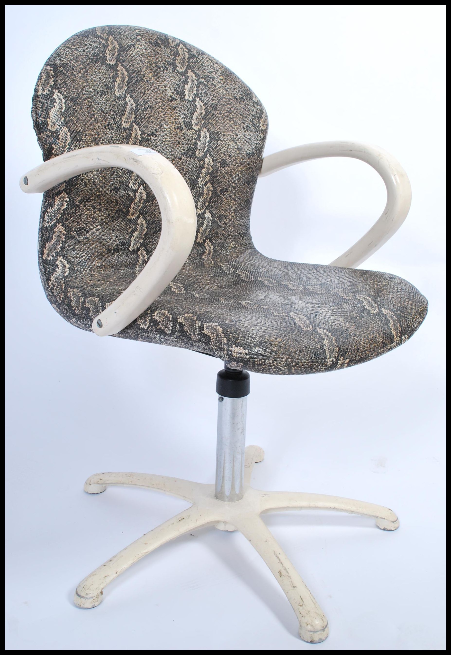 An unusual snakeskin upholstered 1970's office swivel chair having been removed from a Parisian