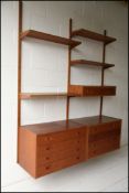 A 1960's mid century teak veneer set of ‘PS System’ shelves and cabinets. Made in Denmark.