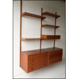 A 1960's mid century teak veneer set of ‘PS System’ shelves and cabinets. Made in Denmark.