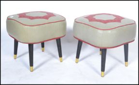 A pair of vintage 20th century retro stools having a red star design raised on tapering ebonised