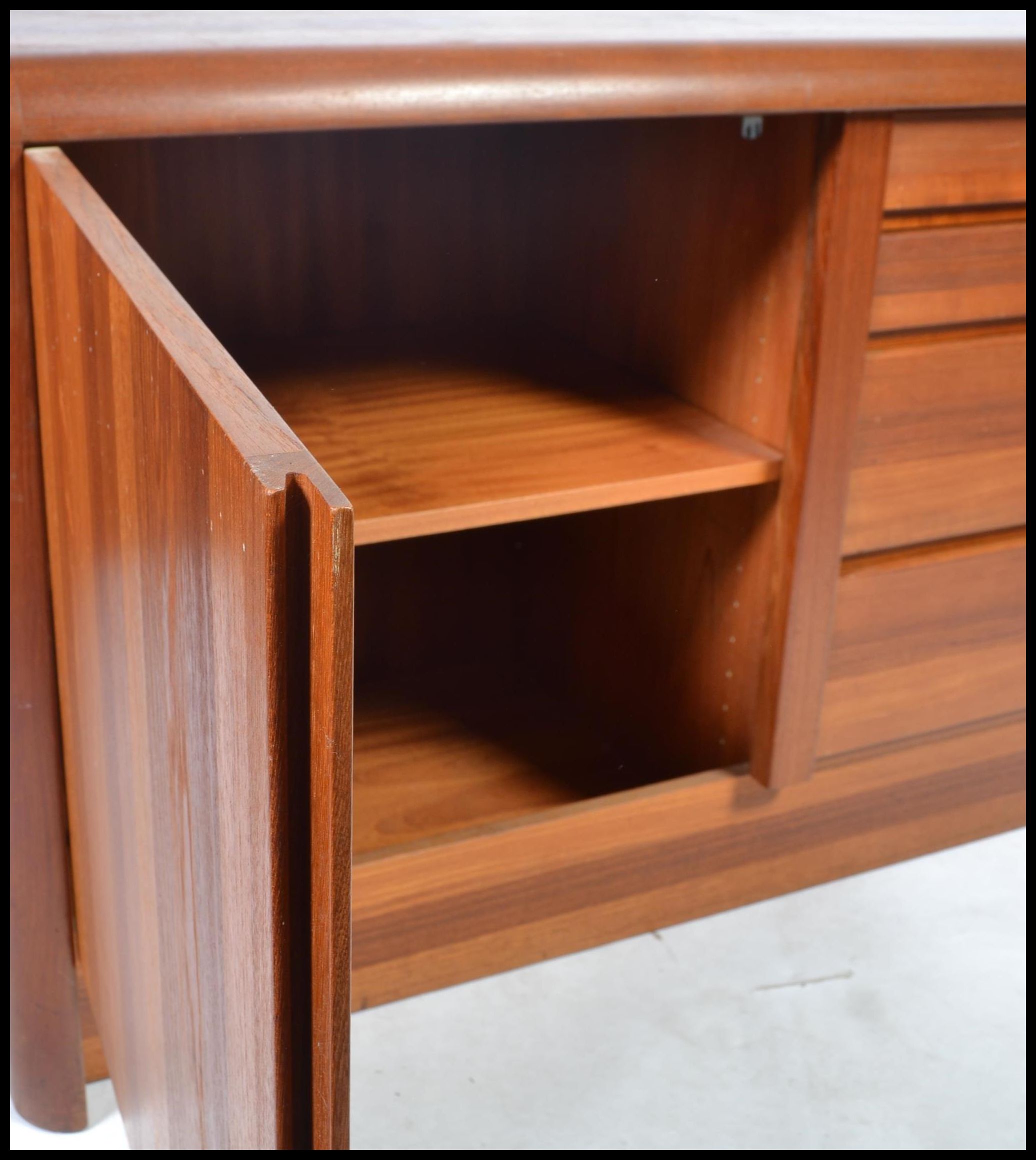 A 20th century Danish sideboard of low form and heavy solid teak construction by Ejvind Johansen - Image 5 of 7