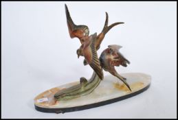 A 1930's Art Deco regule (alloy) diorama statue / figurine pair of flying song / lovebirds having