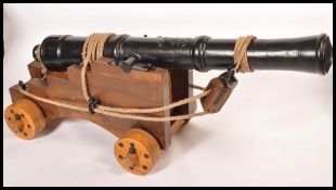 A full sized English Naval Napoleonic replica cannon 4 / 6lb set on wooden carriage. The barrel is