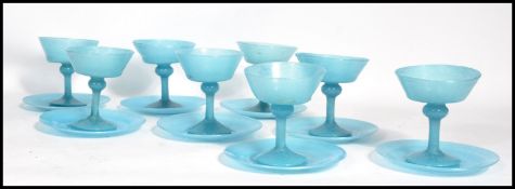 A set of eight vintage 20th century blue glass champagne / dessert glasses and saucers. Raised on