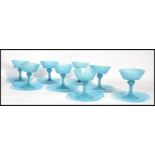 A set of eight vintage 20th century blue glass champagne / dessert glasses and saucers. Raised on