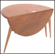 An Ercol retro 1970's drop leaf circular coffee - occasional table by Ercol raised on tapered legs