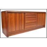 A 20th century Danish sideboard of low form and heavy solid teak construction by Ejvind Johansen