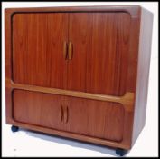 A 1960s / mid 20th century teak tv media cabinet by Dyrlund, Denmark. The cabinet with sliding