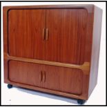 A 1960s / mid 20th century teak tv media cabinet by Dyrlund, Denmark. The cabinet with sliding