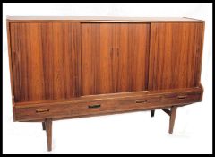 A large 1960's Danish teak sideboard. With central cocktail cabinet and internal drawers. 2 cabinets