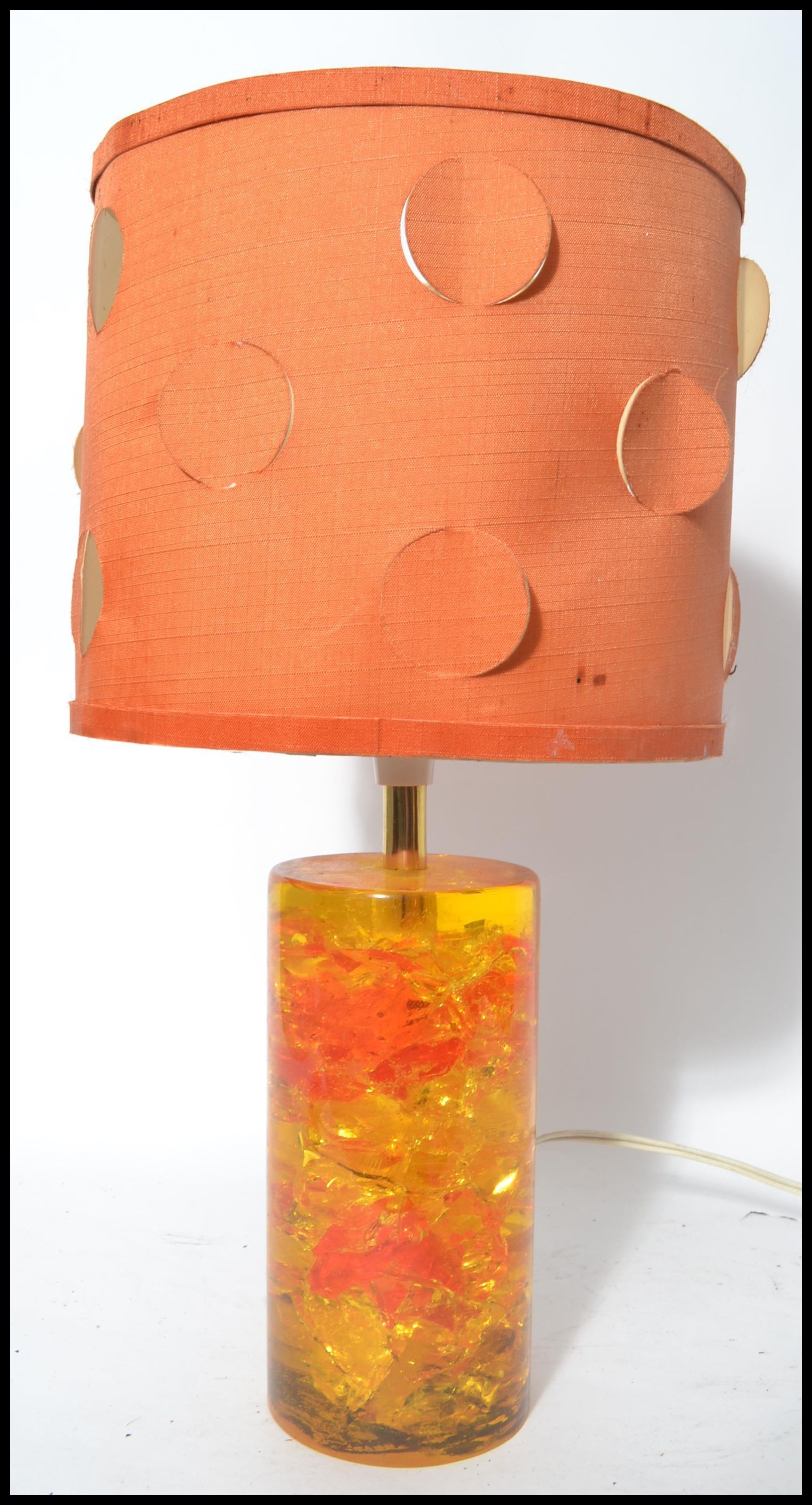 A retro vintage mid 20th century Shatterline amber type resin lamp base in orange having a