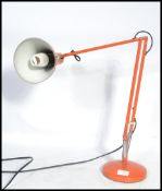 A retro 20th century Herbert Terry anglepoise industrial desk lamp with conical shade raised on a