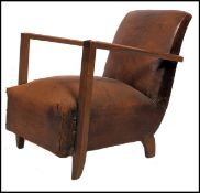An early 20th century leather club armchair. Raised on block feet having an overstuffed seat and
