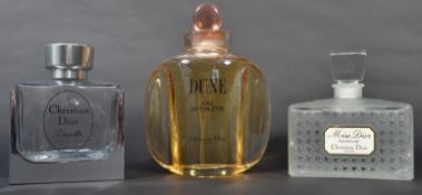 A group of three vintage 20th century advertising point of sale shop display perfume bottles. Dune