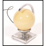 A 1930's Art Deco chrome and glass globe desk  / table lamp. The chrome square plinth base with