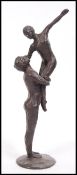 A vintage 20th century bronze statue figurine group of a dancing couple raised on a circular base.