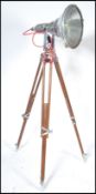 An exceptional large industrial polished steel and wooden tripod theatre light. The stunning