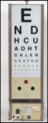 A retro 20th century opticians revolving light box revolving letter board. The grey plinth base with