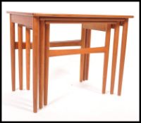 B R Gelstred - A mid century retro teak wood trio nest of tables having squared tops and round