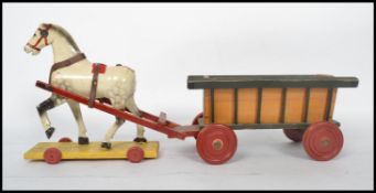 An early 20th century decorative children's wooden horse and cart toy. The painted horse on yellow