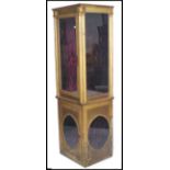 A 19th century French Parisien shop display cabinet. Of upright pedestal form with gilt finish