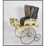 An impressive and large wicker and wrought metal oversized Victorian pram. The large wheels with