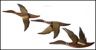 A set of three retro mid 20th century Danish wall hanging Geese, constructed from brass and teak and