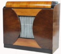 A stunning mid 20th century Defiant radiogram, speaker grill too the centre of the cabinet, lift