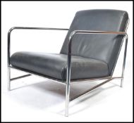 A contemporary early 21st century black leather and chrome low easy lounge chair / armchair having a