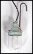 An unusual marine salvage 20th century hanging trouble inspection lamp with glass bulb on light blue