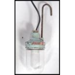 An unusual marine salvage 20th century hanging trouble inspection lamp with glass bulb on light blue