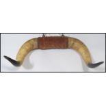 A pair of vintage 20th century mounted ox horns. Each of large form with mounted centre and