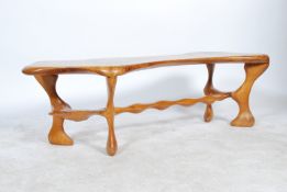 An exceptional 20th century hand carved organic fluid Elm coffee table in the manner of Wendell