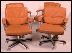 A set of 4 20th century, circa 1970's tan leather swivel desk chairs - office swivel. The desk chair