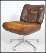 A stunning retro mid 20th century brown leather swivel / office chair, raised on a chrome base